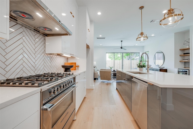 2113 Huldy St, Houston, TX 77019 - kitchen featuring appliances with stainless steel finishes, modern cabinets, a sink, light wood-style flooring, and light countertops
