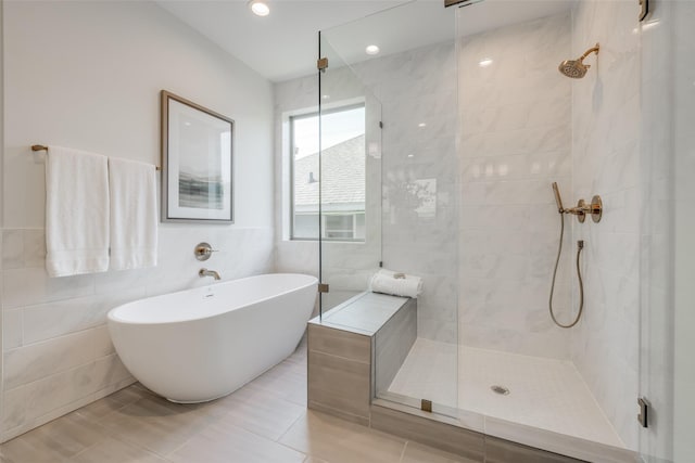 2113 Huldy St, Houston, TX 77019 - bathroom with tiled shower, a freestanding tub, tile walls, and tile patterned flooring