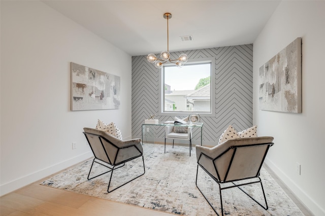 2113 Huldy St, Houston, TX 77019 - office area featuring an accent wall, a chandelier, baseboards, and wood finished floors