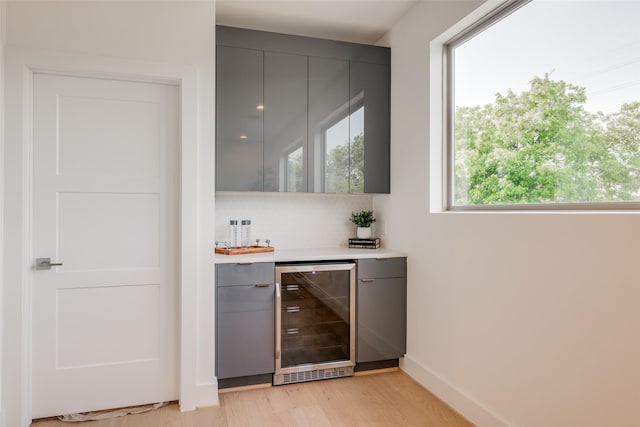 2113 Huldy St, Houston, TX 77019 - indoor dry bar featuring wine cooler, light wood-type flooring, and baseboards