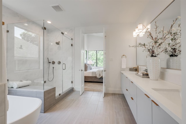 2113 Huldy St, Houston, TX 77019 - ensuite bathroom with double vanity, a soaking tub, a stall shower, baseboards, and recessed lighting