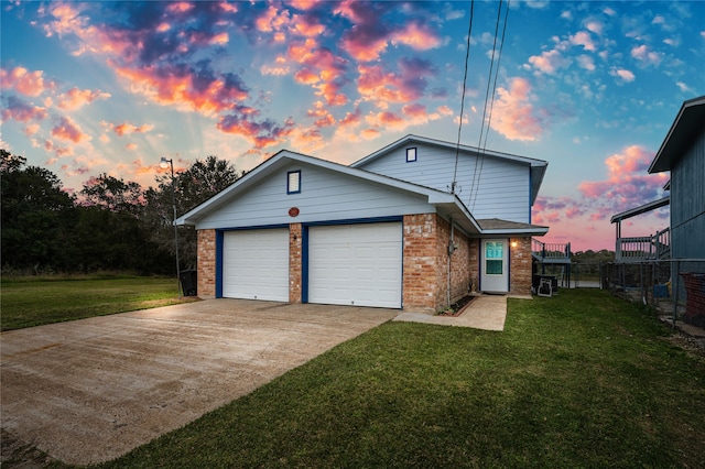 4587 Rio Dr, Brazoria, TX 77422 - back of property featuring driveway, an attached garage, brick siding, and a yard