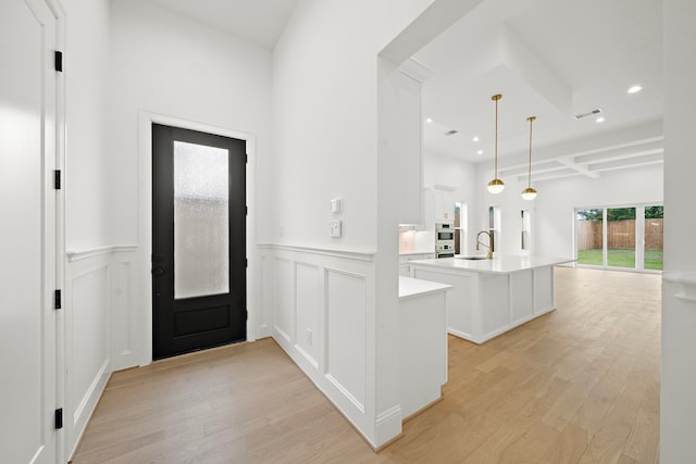 811 W 18th St, Houston, TX 77008 - foyer entrance featuring light wood-style floors, wainscoting, recessed lighting, and a decorative wall