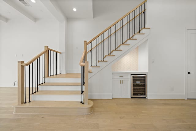 811 W 18th St, Houston, TX 77008 - stairs featuring wine cooler, wood finished floors, a dry bar, and recessed lighting