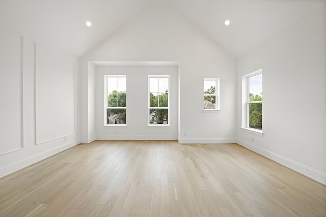 811 W 18th St, Houston, TX 77008 - unfurnished living room featuring plenty of natural light, high vaulted ceiling, light wood finished floors, and recessed lighting