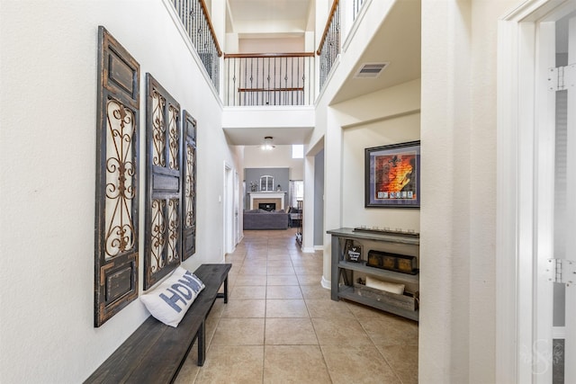 6522 Tamarind Sky Ln, Fulshear, TX 77441 - foyer entrance featuring light tile patterned flooring, a towering ceiling, and a fireplace