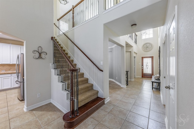 6522 Tamarind Sky Ln, Fulshear, TX 77441 - foyer featuring a high ceiling, light tile patterned floors, and stairs