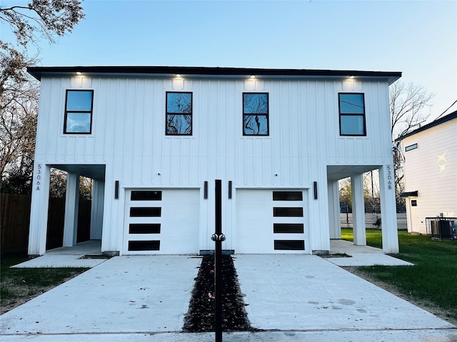 5304 Lynnfield St, Houston, TX 77028 - view of front of house with an attached garage, cooling unit, a carport, concrete driveway, and board and batten siding