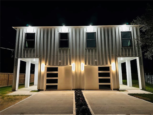 5304 Lynnfield St, Houston, TX 77028 - view of front facade featuring an attached garage, concrete driveway, board and batten siding, and fence