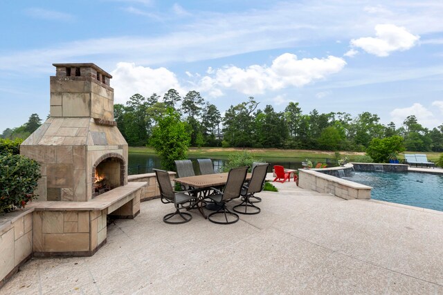 46 Cove View Trail Ct, The Woodlands, TX 77389 - view of patio with an outdoor stone fireplace, an outdoor pool, a water view, and outdoor dining area