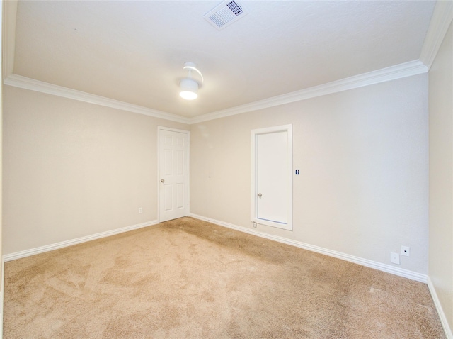 spare room featuring crown molding, visible vents, carpet flooring, and baseboards