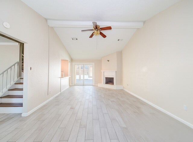 unfurnished living room with stairway, visible vents, lofted ceiling with beams, light wood-style flooring, and ceiling fan