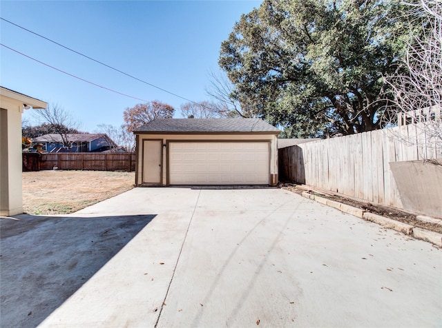 detached garage featuring fence
