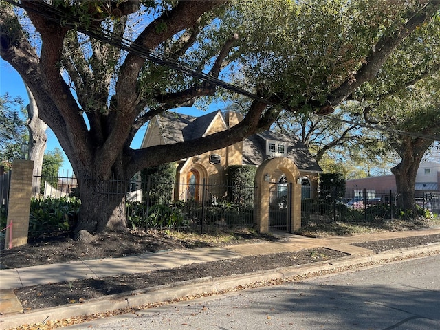 702 Morton St, Richmond, TX 77469 - view of front facade featuring a fenced front yard, a gate, and brick siding