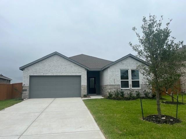 2524 Table Rock Dr, Texas City, TX 77568 - ranch-style home with an attached garage, concrete driveway, a front lawn, and stone siding