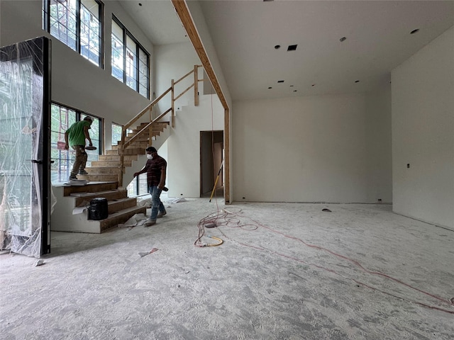 11411 Dunbeath Dr, Houston, TX 77024 - unfurnished living room featuring a high ceiling and stairs