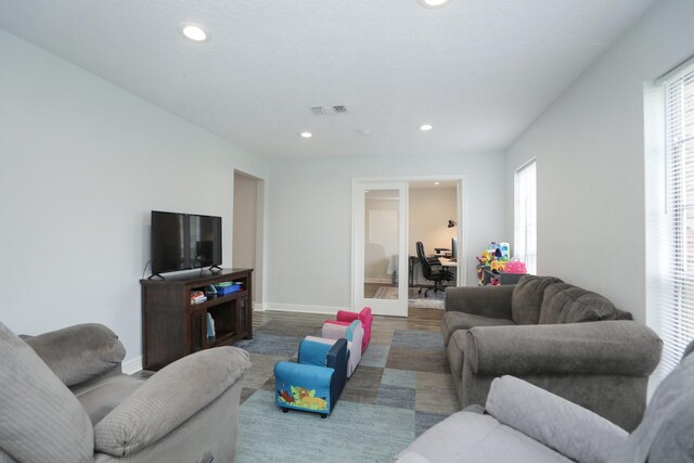 living area featuring recessed lighting, an office area, wood finished floors, and baseboards