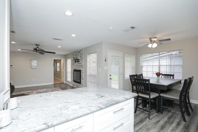 kitchen with ceiling fan, light wood-style flooring, baseboards, white cabinetry, and recessed lighting
