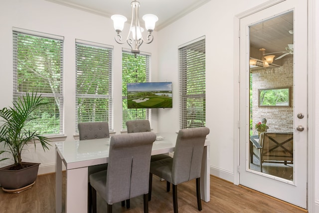 114 Pacific Grove Dr, Montgomery, TX 77316 - dining room featuring a wealth of natural light, ornamental molding, wood finished floors, and a notable chandelier