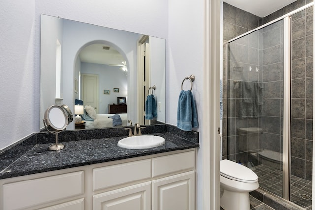 114 Pacific Grove Dr, Montgomery, TX 77316 - bathroom featuring vanity, toilet, ceiling fan, a shower stall, and ensuite bath