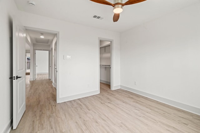 1009 Genova St, Houston, TX 77009 - unfurnished bedroom with light wood-style flooring, attic access, baseboards, a spacious closet, and ceiling fan
