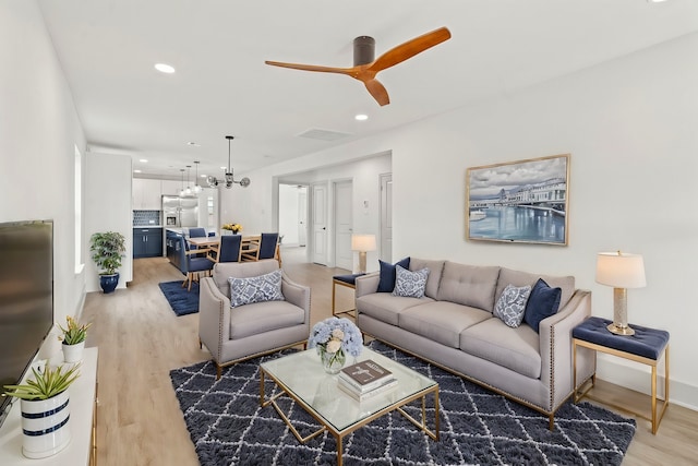 1009 Genova St, Houston, TX 77009 - living room with light wood-style flooring, a chandelier, a ceiling fan, baseboards, and recessed lighting