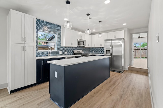 1009 Genova St, Houston, TX 77009 - kitchen with appliances with stainless steel finishes, healthy amount of natural light, a sink, light wood-style floors, and recessed lighting