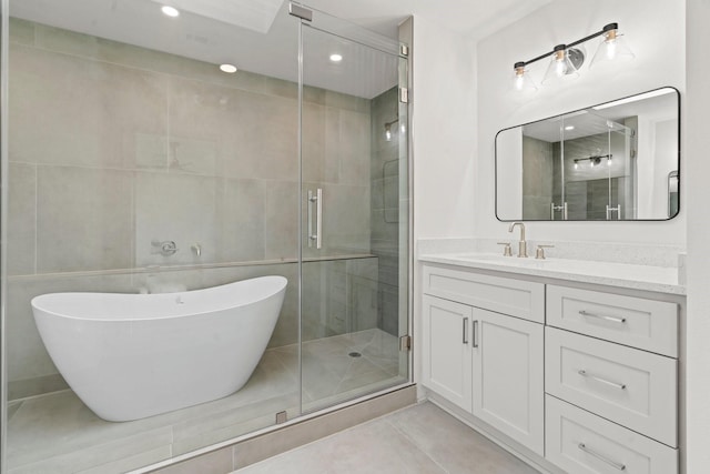 1009 Genova St, Houston, TX 77009 - full bath featuring vanity, a stall shower, a freestanding tub, tile patterned floors, and recessed lighting