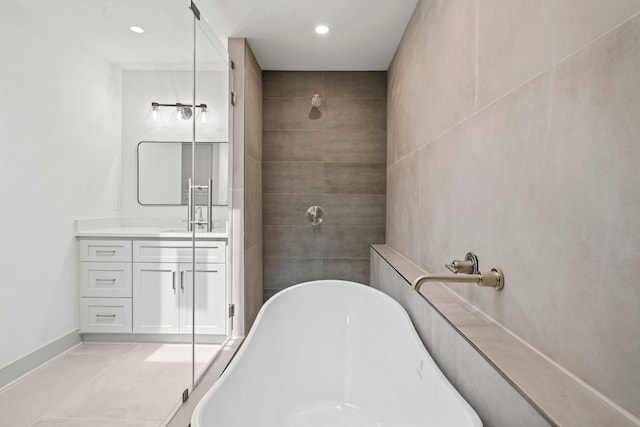 1009 Genova St, Houston, TX 77009 - full bath with vanity, a freestanding bath, tiled shower, recessed lighting, and tile patterned floors