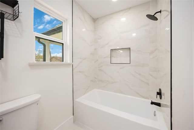 full bathroom featuring toilet, baseboards, and shower / washtub combination
