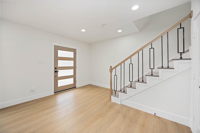 foyer with baseboards, light wood-style floors, stairway, and recessed lighting