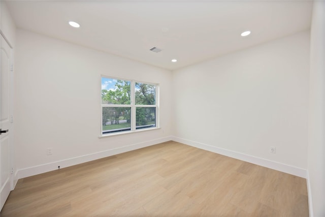 spare room featuring baseboards, visible vents, recessed lighting, and light wood-type flooring
