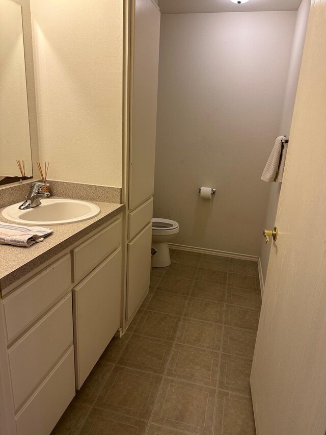 833 E Camp St, La Grange, TX 78945 - bathroom featuring baseboards, toilet, and vanity