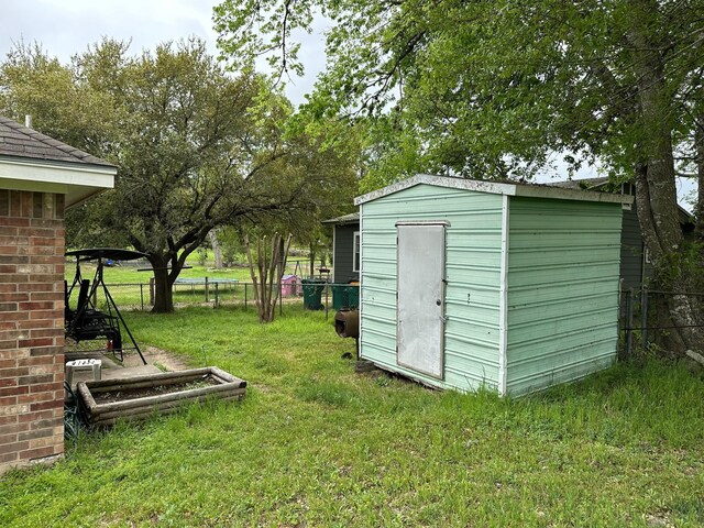 833 E Camp St, La Grange, TX 78945 - view of yard with an outdoor structure, a storage unit, and fence