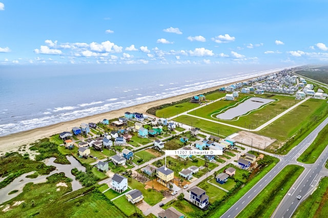 bird's eye view with a water view and a view of the beach