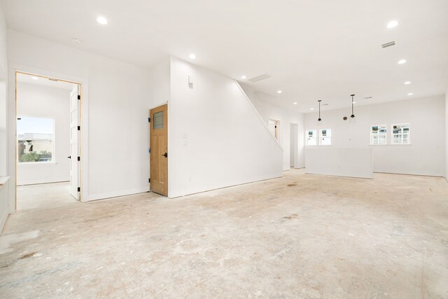 empty room featuring a wealth of natural light and recessed lighting
