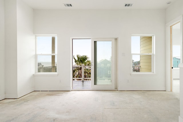 empty room with visible vents and a healthy amount of sunlight