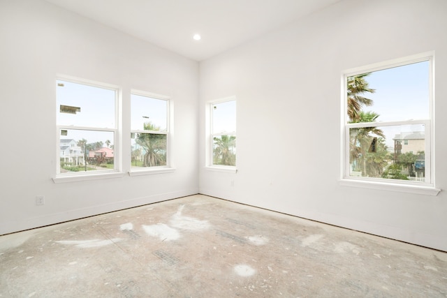 unfurnished room with baseboards