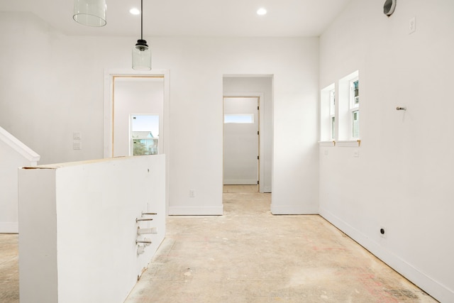 interior space with baseboards and recessed lighting