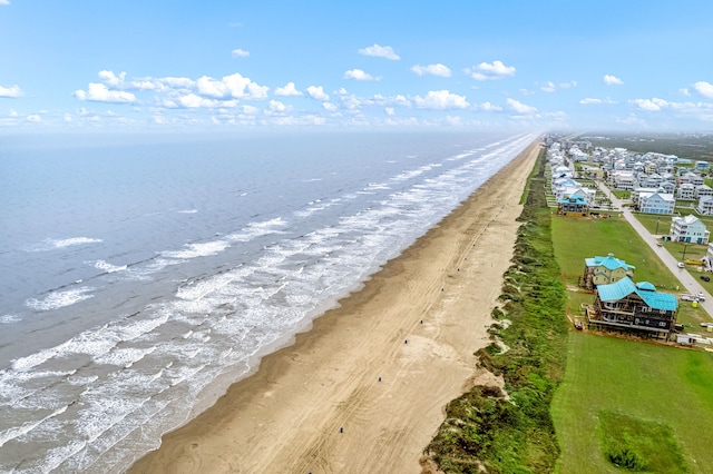 drone / aerial view with a water view and a view of the beach