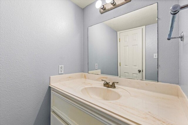 215 Postoffice St Unit 1004, Galveston, TX 77550 - bathroom with a textured wall and vanity
