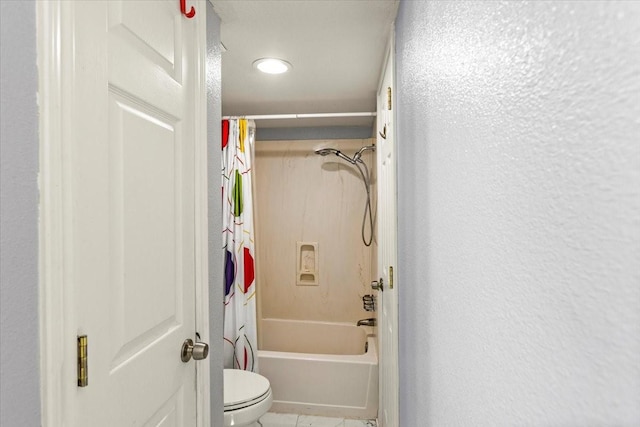 215 Postoffice St Unit 1004, Galveston, TX 77550 - bathroom featuring toilet, shower / bath combo, a textured wall, and tile patterned floors