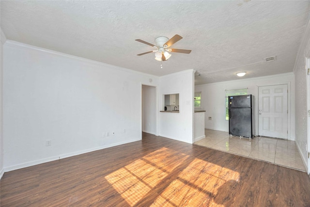 10522 Fairland Dr, Houston, TX 77051 - unfurnished living room with crown molding, a ceiling fan, wood finished floors, a textured ceiling, and baseboards