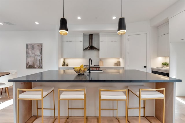 1128 W Pierce St, Houston, TX 77019 - kitchen with wall chimney exhaust hood, modern cabinets, tasteful backsplash, recessed lighting, and white cabinets