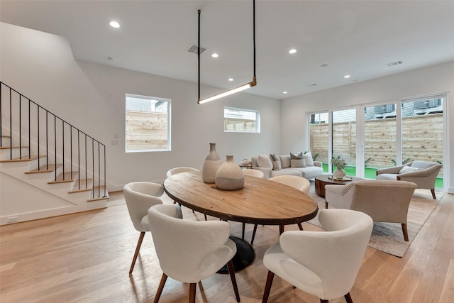 1128 W Pierce St, Houston, TX 77019 - dining area with light wood-style floors, recessed lighting, healthy amount of natural light, and stairs