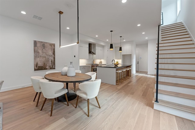 1128 W Pierce St, Houston, TX 77019 - dining area with light wood finished floors, stairs, and recessed lighting