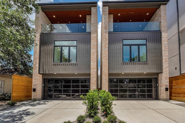 1128 W Pierce St, Houston, TX 77019 - contemporary house featuring a garage, driveway, and brick siding