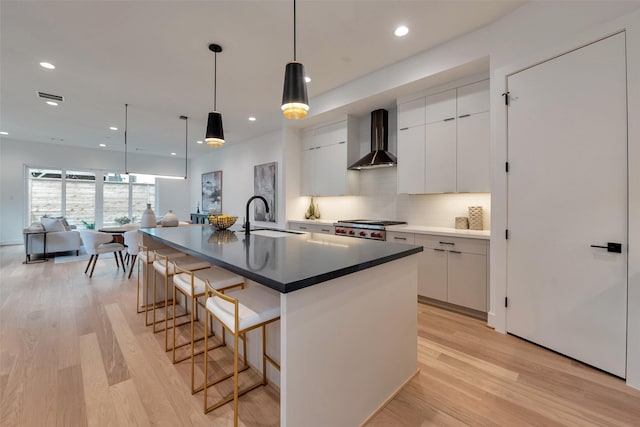 1128 W Pierce St, Houston, TX 77019 - kitchen with wall chimney exhaust hood, modern cabinets, tasteful backsplash, white cabinetry, and recessed lighting