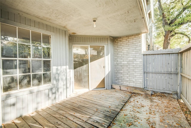 wooden terrace featuring fence