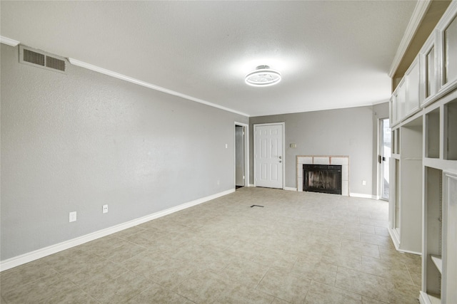 unfurnished living room featuring baseboards, visible vents, a tiled fireplace, and ornamental molding